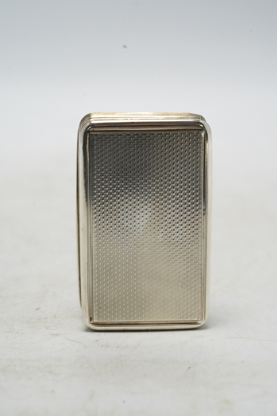 A late George III engine turned silver snuff box, William Elliot, London, 1819, 74mm, with interior engraved inscription. Condition - fair to good